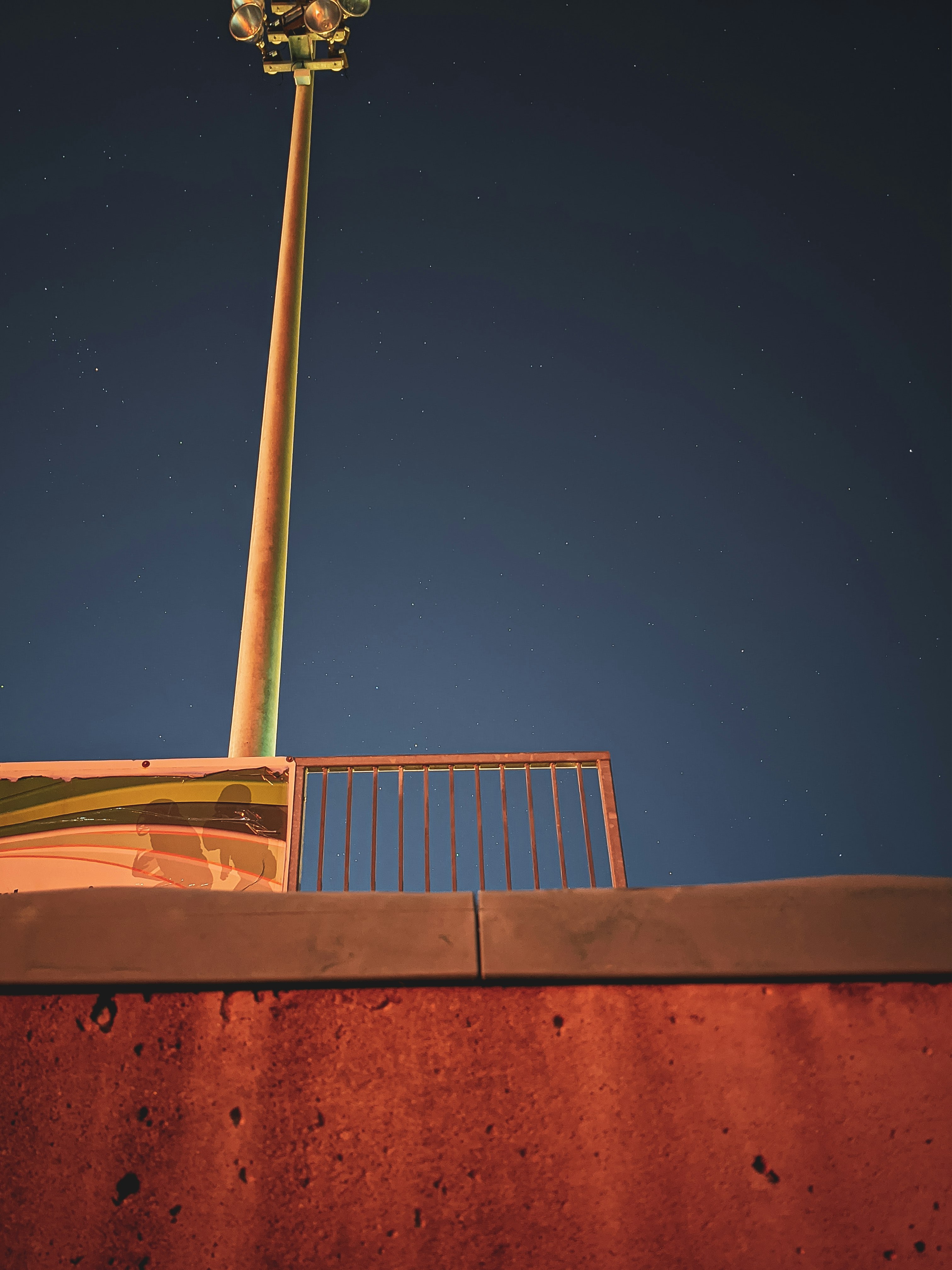 white metal railings under blue sky during night time